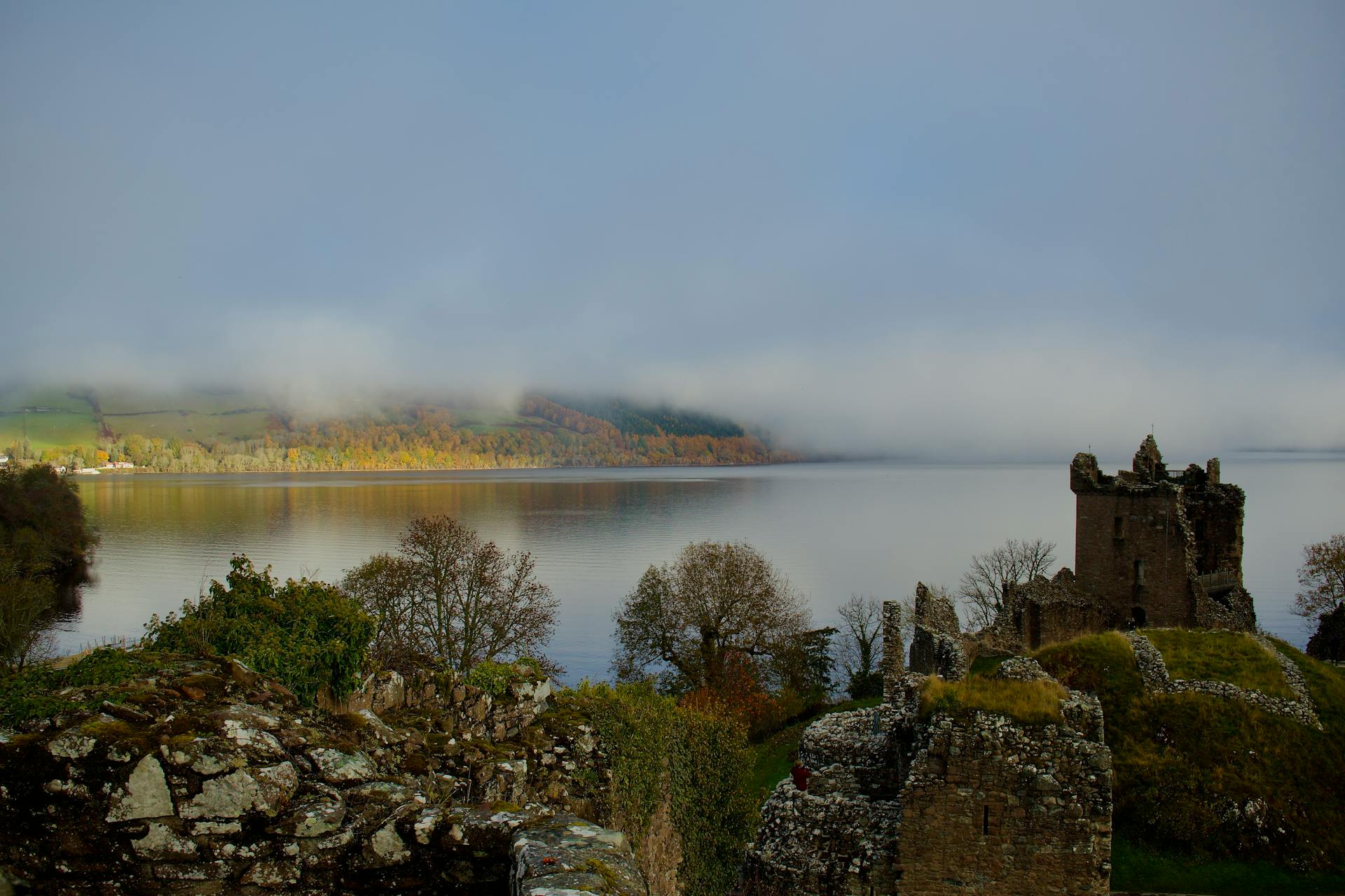 The ruins of Urquhart Castle dominating Loch Ness under a dramatic sky. It is one of the most iconic images of the Scottish Highlands.